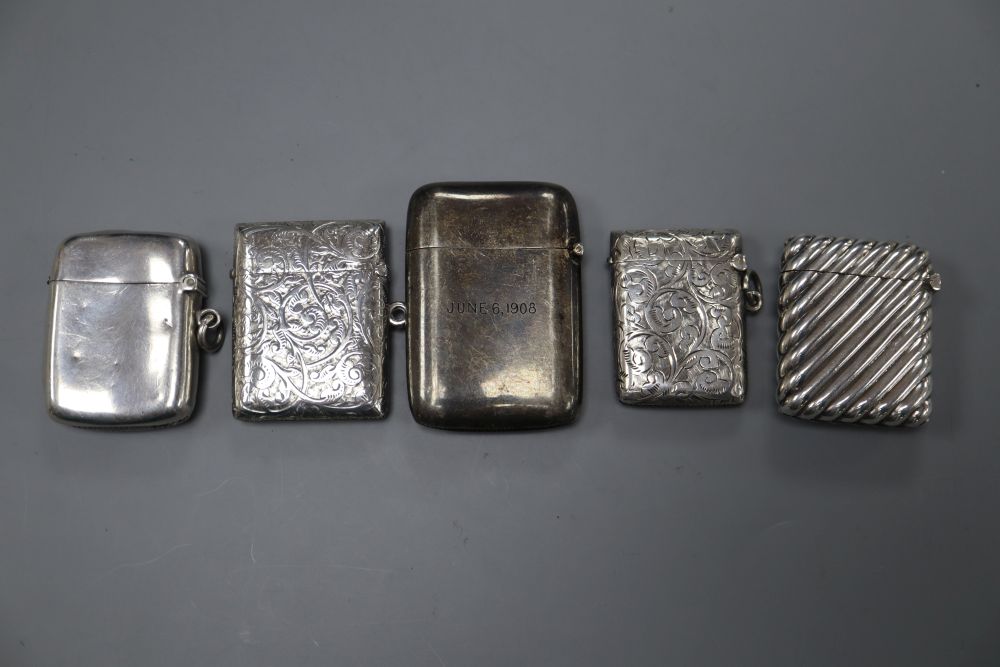 Three silver vesta cases, a sterling vesta case and a white metal vesta case, largest 61mm.